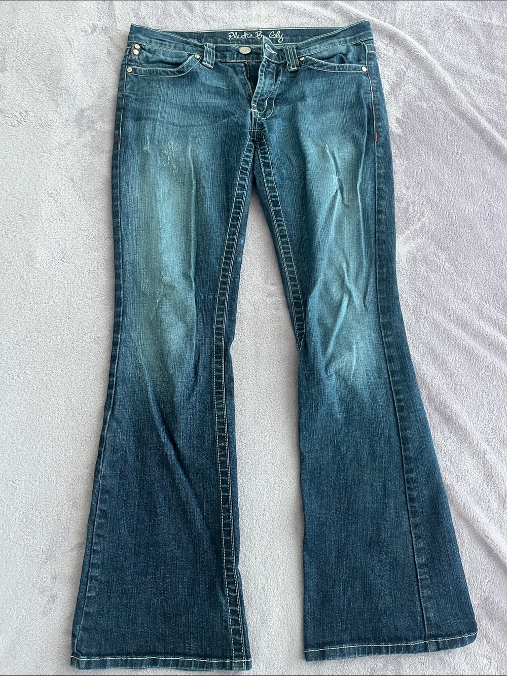 Y2K/2000s style low rise jeans with distressed and stitching details
